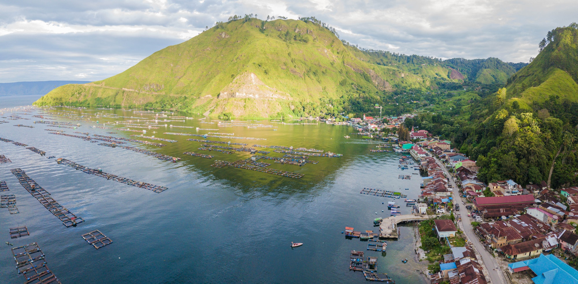 Aerial drone shot of Batak Village by Toba Lake at Haranggaol in Sumatra Utara, Indonesia